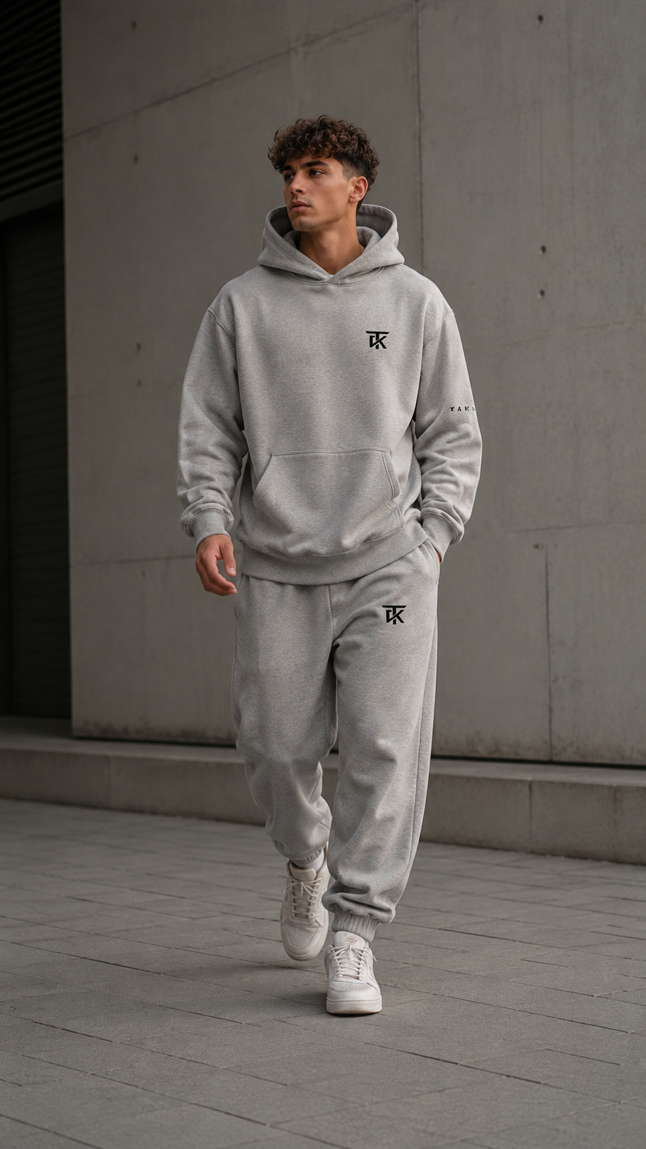 TAKI model in the light grey TAKI tracksuit