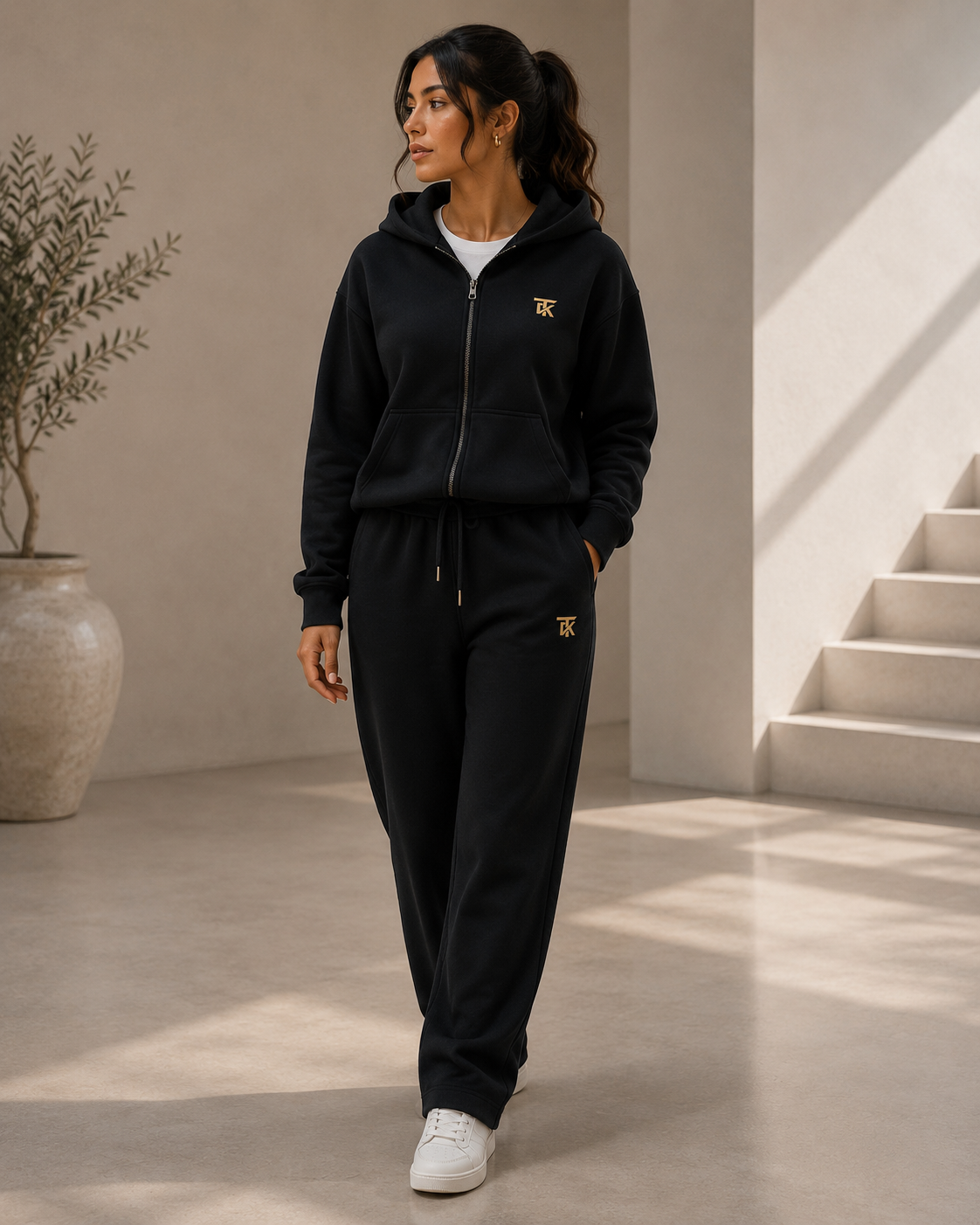 TAKI model in the black TAKI tracksuit